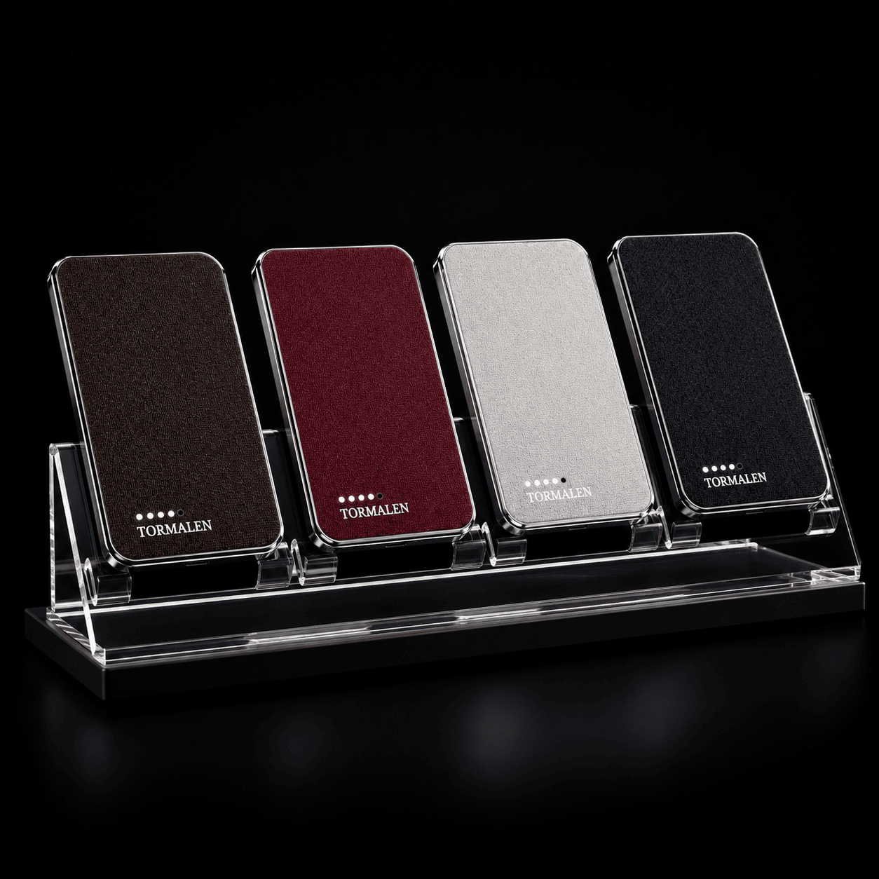 Four TORMALEN power bank colors on an acrylic display stand