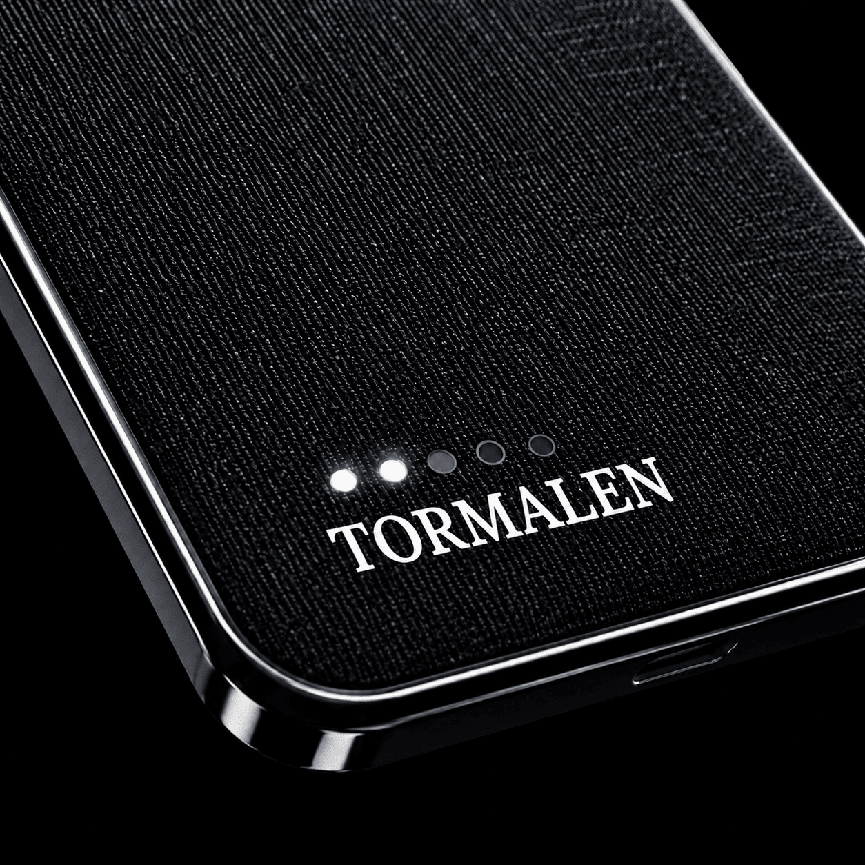 Macro of premium fabric texture with LED indicator and TORMALEN logo